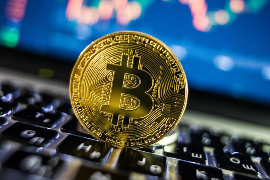 A bitcoin on a keyboard.