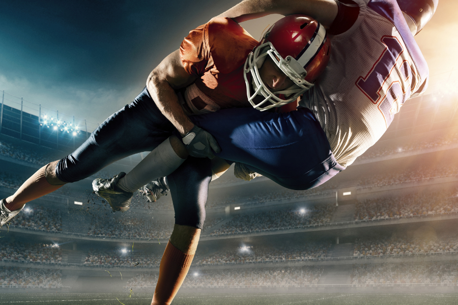 American football players tackling each other.
