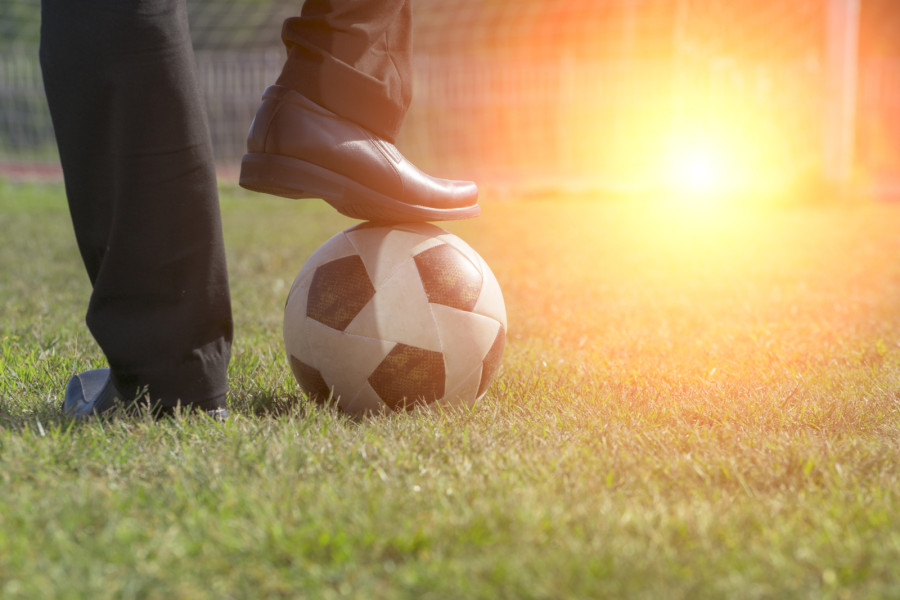 A leg being placed on a ball.