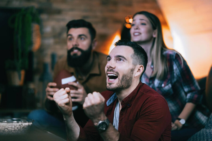 Group cheering for a sports bet with a betting license in South Africa.