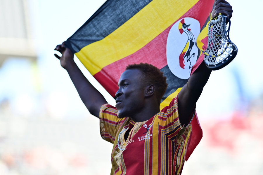 A man waving the flag of Uganda.
