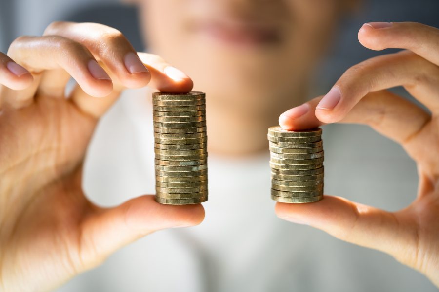 A person holding a stack of coins.