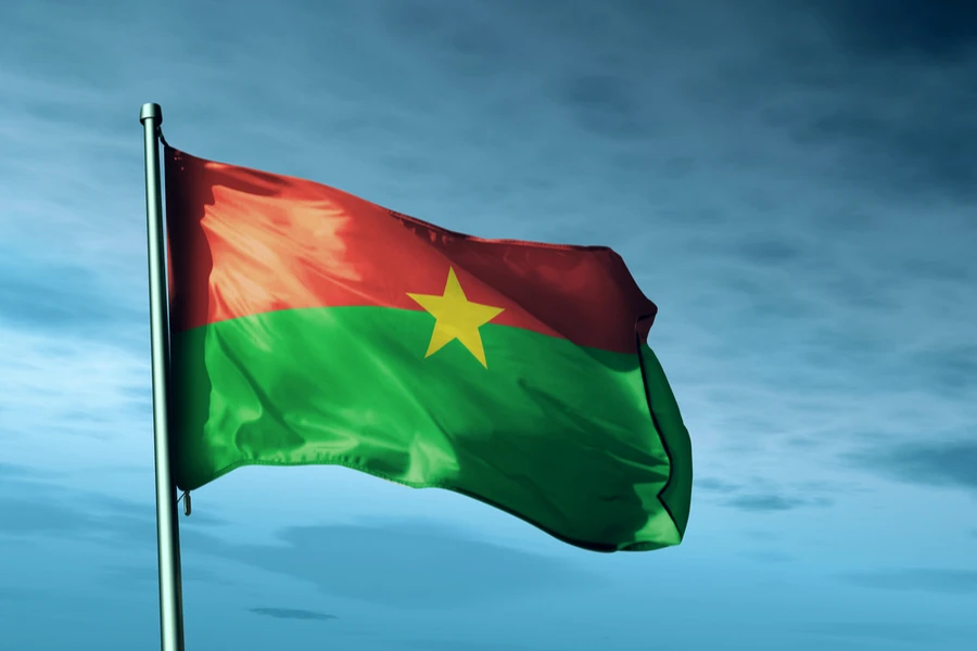 The flag of Burkina Faso hoisted in the skies.