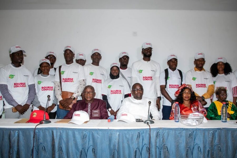 LONAGUI executive members celebrate with young Guineans who were awarded full Master’s scholarships during the public draw