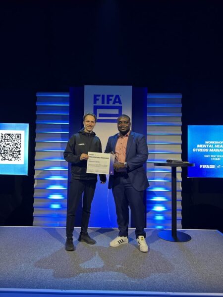 Emmanuel Lawson (right), Ghana’s first FIFAe-licenced referee, receives his certificate from a FIFAe representative. 