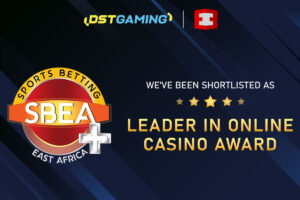 A promotional graphic announcing that DSTGAMING has been shortlisted for the ‘Leader in Online Casino Award’ at the Sports Betting East Africa (SBEA+) awards. The design features five gold stars above the award title in gold lettering, with the SBEA+ logo on the left and the DSTGAMING logo at the top, set against a dark blue background.