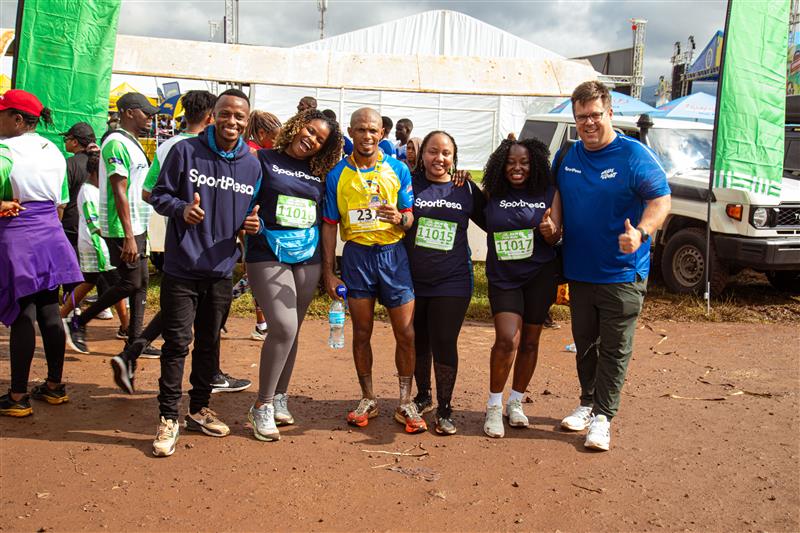 SportPesa-sponsored runner John April (third left) celebrates with the team at the 2026 Kilimanjaro Marathon.