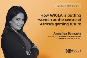 A promotional interview graphic. On the left side, a black-and-white portrait features Annalisa Samuels. In the upper right, a pill-shaped outline contains the text ‘Exclusive Interview’. Below this, the main headline is written in bold, dark grey letters: ‘How WIGLA is putting women at the centre of Africa's gaming future’. Samuels’ name and her job title, ‘Group CEO, Women in Gaming and Lotteries Africa (WIGLA)’, are printed in dark grey towards the bottom right, and the Focus Gaming News logo is positioned in the bottom-right corner.