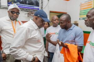 LONACI Director General Dramane Coulibaly speaks with a retailer during a field visit to betting outlets. 