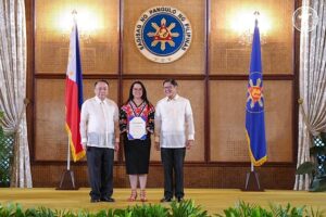 PAGCOR President and COO Wilma Eisma (center) receives a plaque of recognition from President Ferdinand R. Marcos JR. for the state gaming agency’s role in the country's successful removal from the Financial Action Task Force grey list. Also in photo is Executive Secretary and National Anti-Money Laundering/Counter-Proliferation Financing/Counter-Terrorism Financing Coordination Council Chairman Lucas P. Bersamin (left).