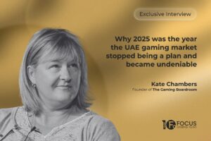 A promotional graphic for an ‘Exclusive Interview’ with Kate Chambers, Founder of The Gaming Boardroom. The design features a black-and-white portrait of Chambers on the left, set against a textured, golden gradient background. On the right, the main headline reads, ‘Why 2025 was the year the UAE gaming market stopped being a plan and became undeniable’. The Focus Gaming News logo is positioned in the bottom-right corner.