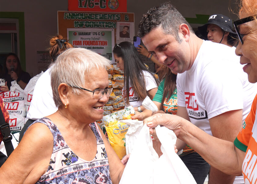 People receiving bags from the FBM Foundation.