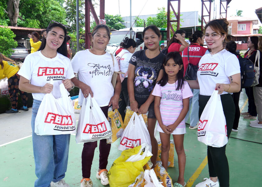 People receiving bags from the FBM Foundation.