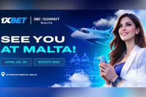 A promotional graphic for 1xBet’s attendance at the SBC Summit Malta on 29-30 April. The image features a smiling woman in a white blazer holding a smartphone, with a sleek private jet and a blue-tinted Malta skyline in the background. The text includes ‘SEE YOU AT MALTA!’, ‘BOOTH B40’, and the venue, ‘Intercontinental Malta’.