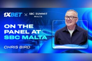 1xBet x SBC Summit Malta banner reading ‘On the Panel at SBC Malta – Chris Bird’, featuring Chris Bird speaking on stage with blue conference-themed graphics.