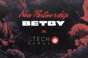 A promotional graphic announcing a ‘New Partnership’ between BETBY and QTech Games. The design features traditional Japanese-style illustrations in shades of red and dark blue, including a samurai with a katana, a dragon, a crane, and crashing ocean waves. The BETBY and QTech Games logos are centrally displayed, separated by a small red ‘x’.