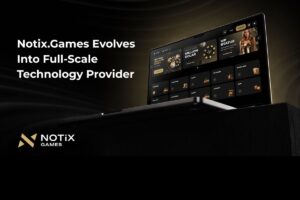 A promotional graphic announcing that ‘Notix.Games Evolves Into Full-Scale Technology Provider’. The image features a laptop displaying a luxury-themed online gaming interface with gold and black accents. The screen showcases sections for ‘VIP STATUS’, ‘WELCOME BONUS’, and various categories including ‘SLOTS’, ‘LIVE CASINO’, and ‘BLACKJACK’. The Notix Games logo is positioned in the bottom-left corner against a dark, elegant background.