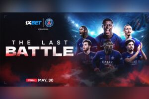A promotional sports graphic set against a dark, smoky background with red clouds along the bottom and bright stadium floodlights at the top. On the right side, six Paris Saint-Germain football players are pictured wearing their dark blue home kits featuring the ‘Qatar Airways’ sponsor logo; some are shouting in celebration whilst others look determined. On the left side, the main headline reads ‘THE LAST BATTLE’ in bold white lettering. Above the headline, the 1xBet logo stands next to the Paris Saint-Germain club crest, accompanied by the text ‘OFFICIAL PARTNER’. At the bottom left, a small red tag reads ‘FINAL’ next to the white text ‘MAY, 30’.