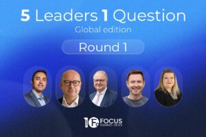 A promotional graphic for Focus Gaming News titled ‘5 Leaders 1 Question: Global edition’, with a subheader reading ‘Round 1’ inside a blue pill-shaped button. The background is a dark blue gradient that lightens towards the top. Across the lower section, five round portrait cutouts feature different industry leaders side by side. From left to right: a man in a grey suit jacket, a man with glasses in a dark jacket and white shirt, a man with glasses wearing a dark suit and pink tie, a smiling man in a grey t-shirt, and a woman with blonde hair wearing a black blazer. The Focus Gaming News logo is positioned in the bottom-centre.
