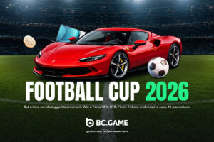 A promotional graphic for BC.GAME titled ‘FOOTBALL CUP 2026’ in bold white and green lettering, set against a packed football stadium backdrop. The foreground features a sleek red Ferrari sports car parked on the pitch, next to a classic black-and-white football on the right. A gold Bitcoin coin and a flat-screen television float to the left of the vehicle. Below the main title, smaller white text reads: ‘Bet on the world’s biggest tournament. Win a Ferrari 296 GTB, Finals Tickets, and massive cash. 10 promotions.’ The BC.GAME logo, along with GambleAware and age-restriction disclaimers, is positioned along the bottom.