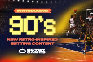 A promotional graphic for Betby Games announcing their latest release. The main text reads ‘INTRODUCING’ on an orange-red banner, above a large, yellow, pixelated ‘90's’, followed by the subheading ‘NEW RETRO-INSPIRED BETTING CONTENT’. The background features a retro, arcade-style illustration of a basketball match in a packed stadium.