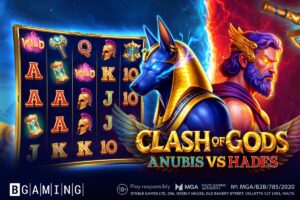 Promotional artwork for the online slot game ‘Clash of Gods: Anubis vs Hades’ by BGaming. The graphic features a central confrontation between the Egyptian god Anubis and the Greek god Hades, divided by a clash of blue and red energy. On the left, a 5x4 slot game reel is displayed with various mythological symbols, such as Spartan helmets, scales, and Egyptian scepters, against a dark blue background. In the centre, the jackal-headed Anubis is depicted with glowing blue eyes, while Hades appears on the right with purple hair and glowing orange eyes against a backdrop of fiery red lightning. The BGaming logo and Malta Gaming Authority regulatory details are positioned along the bottom.