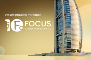 A promotional graphic for Focus Gaming News announcing the introduction of ‘FOCUS UNITED ARAB EMIRATES’. The image features the iconic sail-shaped Burj Al Arab hotel in Dubai on the right, set against a warm golden sky and tranquil water. On the left, the text ‘We are proud to introduce’ is displayed in white above the ‘10 YEARS FOCUS UNITED ARAB EMIRATES’ logo.
