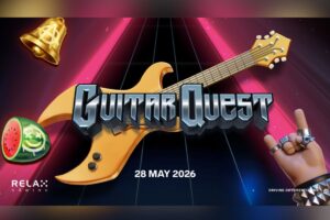 A promotional graphic for the online slot game ‘GUITAR QUEST’ by Relax Gaming. The background depicts a dark, glowing stage with a guitar fretboard extending into the distance under pink spotlight beams. In the centre, the game's title is presented in a heavy, metallic chrome font positioned over a golden electric guitar.