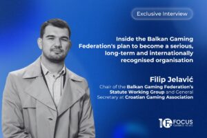 A promotional interview graphic. On the left side, a black-and-white portrait features Filip Jelavić. In the upper right, a translucent white pill-shaped outline contains the text ‘Exclusive Interview’. Below this, the main headline is written in bold white letters: ‘Inside the Balkan Gaming Federation's plan to become a serious, long-term and internationally recognised organisation’. Jelavić’s name and his titles, ‘Chair of the Balkan Gaming Federation’s Statute Working Group and General Secretary at Croatian Gaming Association’, are printed in white towards the bottom right, with the Focus Gaming News logo positioned in the bottom-right corner.