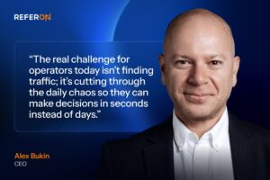 A promotional feature graphic set. On the right, a colour portrait shows a Alex Bukin. In the upper-left corner, the ‘REFERON’ logo is displayed. Occupying the centre-left is a large white quotation enclosed within a translucent, thin-bordered rectangular panel: “The real challenge for operators today isn’t finding traffic; it’s cutting through the daily chaos so they can make decisions in seconds instead of days.” In the bottom-left corner, his name is printed in orange as ‘Alex Bukin’, with his title ‘CEO’ written in white directly underneath.