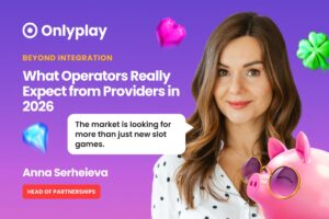 A promotional feature graphic set against a vibrant purple background decorated with floating 3D icons, including a blue diamond, a pink gem-like heart, and a green four-leaf clover. On the right, a colour portrait features Anna Serheieva, with a 3D pink piggy bank wearing round sunglasses overlaid on her shoulder. In the top-left corner, the white ‘Onlyplay’ logo is displayed above yellow text reading ‘BEYOND INTEGRATION’. Below this, the main headline is written in large white font: ‘What Operators Really Expect from Providers in 2026’. A white speech bubble next to Serheieva contains the quote: ‘The market is looking for more than just new slot games.’ In the bottom-left corner, her name is printed in white as ‘Anna Serheieva’, positioned above a red rounded rectangular badge containing ‘HEAD OF PARTNERSHIPS’ in white capital letters.