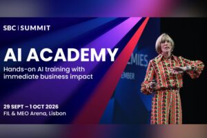 A promotional event graphic for SBC Summit, featuring a dynamic background with blue, purple, and red diagonal geometric rays. In the top-left corner, the white ‘SBC | SUMMIT’ logo is displayed above the main heading ‘AI ACADEMY’ in large, bold white capital letters. Below this, white text reads ‘Hands-on AI training with immediate business impact’. The event details appear in the lower-left corner as ‘29 SEPT – 1 OCT 2026’ and ‘FIL & MEO Arena, Lisbon’.