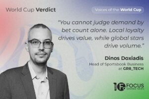 A promotional feature graphic from the ‘Voices of the World Cup’ series by Focus Gaming News, set against a soft, grainy gradient background transitioning from red on the left through blue to green on the right. In the top-left corner, dark grey text reads ‘World Cup Verdict’. On the left side, a black-and-white portrait features Dinos Doxiadis. On the upper right, a white pill-shaped graphic contains the text ‘Voices of the World Cup’. Below it, an italicised dark grey quote reads: “You cannot judge demand by bet count alone. Local loyalty drives value, while global stars drive volume.” Doxiadis’ name and his job title, ‘Head of Sportsbook Business at GR8_TECH’, are printed beneath the quote, with the Focus Gaming News 10 Years logo positioned in the bottom-right corner.